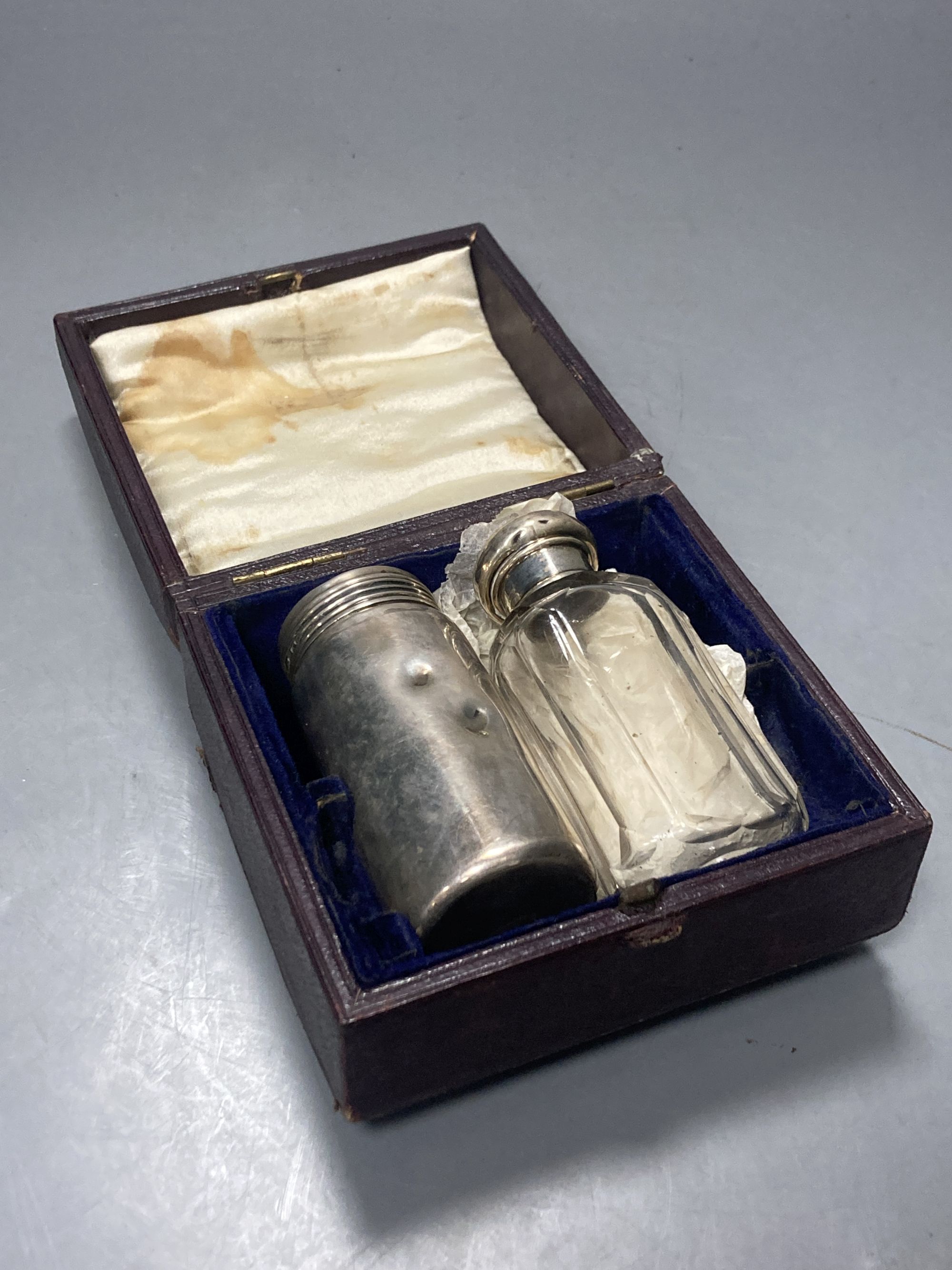 Three silver mounted travelling jars, two in a case, largest 17.1cm,